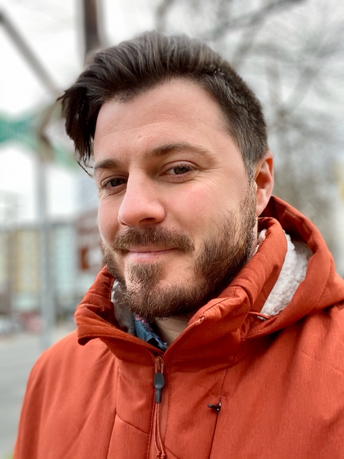 Kyle Begeman outdoors in an orange jacket